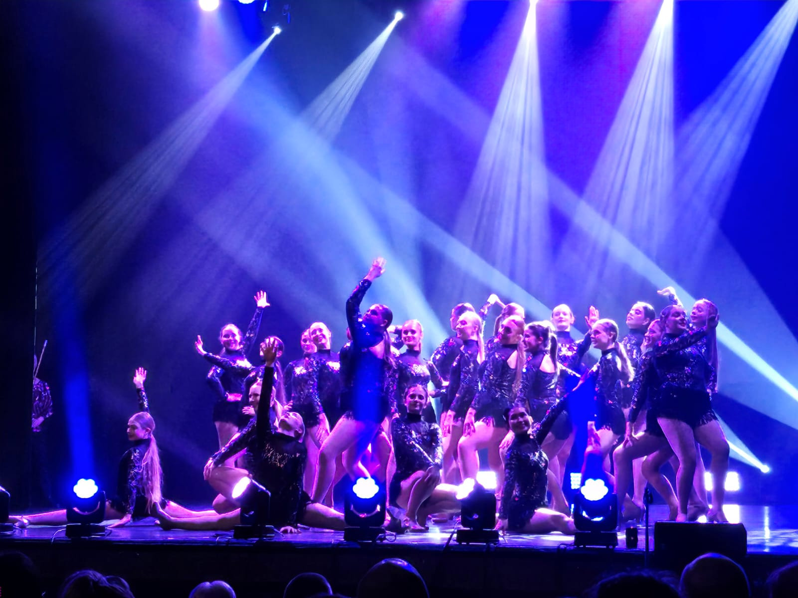 Whittaker's students performing under stage lights at the Grand Theatre Blackpool
