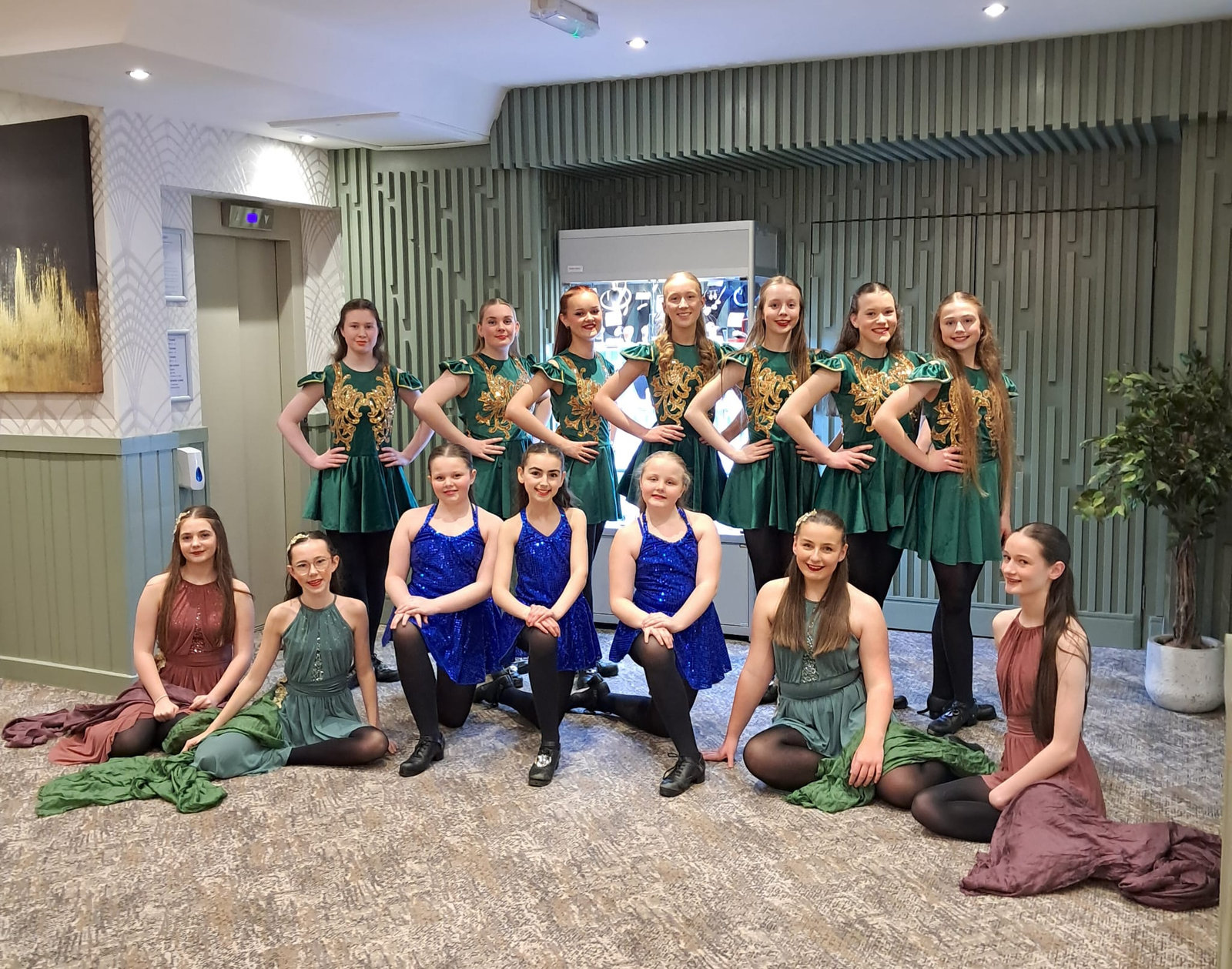Senior Whittaker's students in green and burgundy costumes photographed together