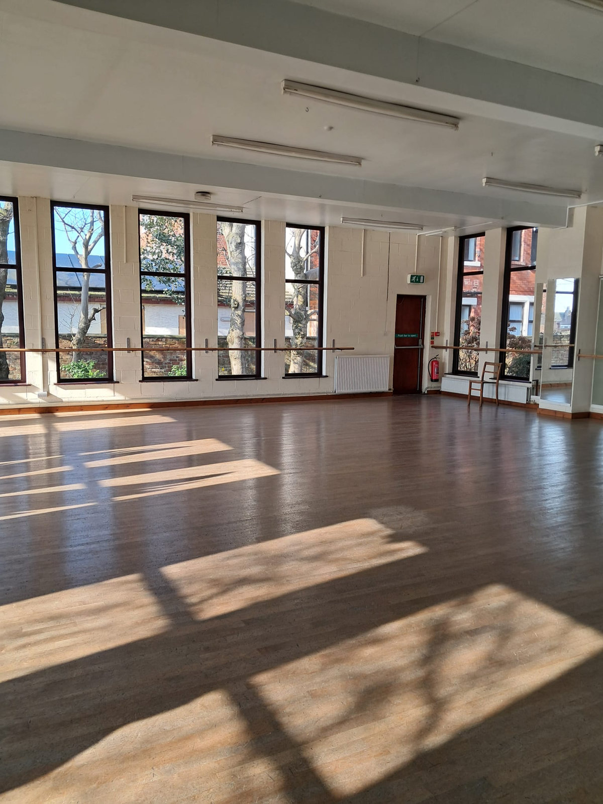 The main dance studio with sprung floor and tall windows